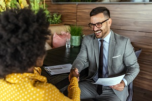 business owner shaking hands with customer